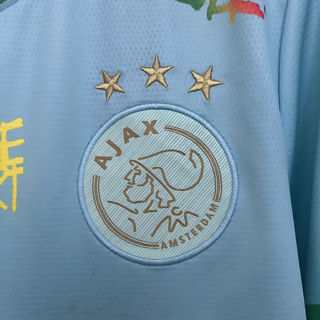 Camiseta Ajax 25/26 Edición Especial Bob Marley Celeste