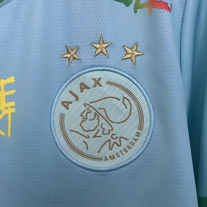 Camiseta Ajax 25/26 Edición Especial Bob Marley Celeste